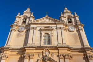 Why Do Churches in Malta Show Two Different Times?