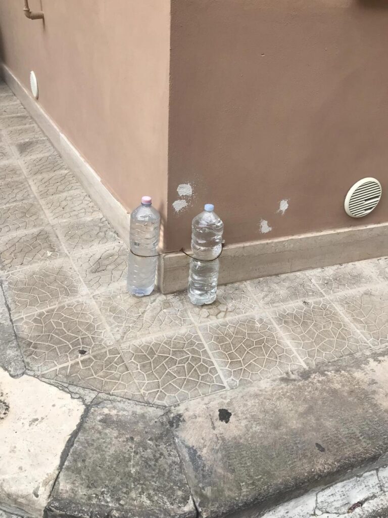 Why Do Maltese People Keep Water-Filled Bottles Outside Their Houses?