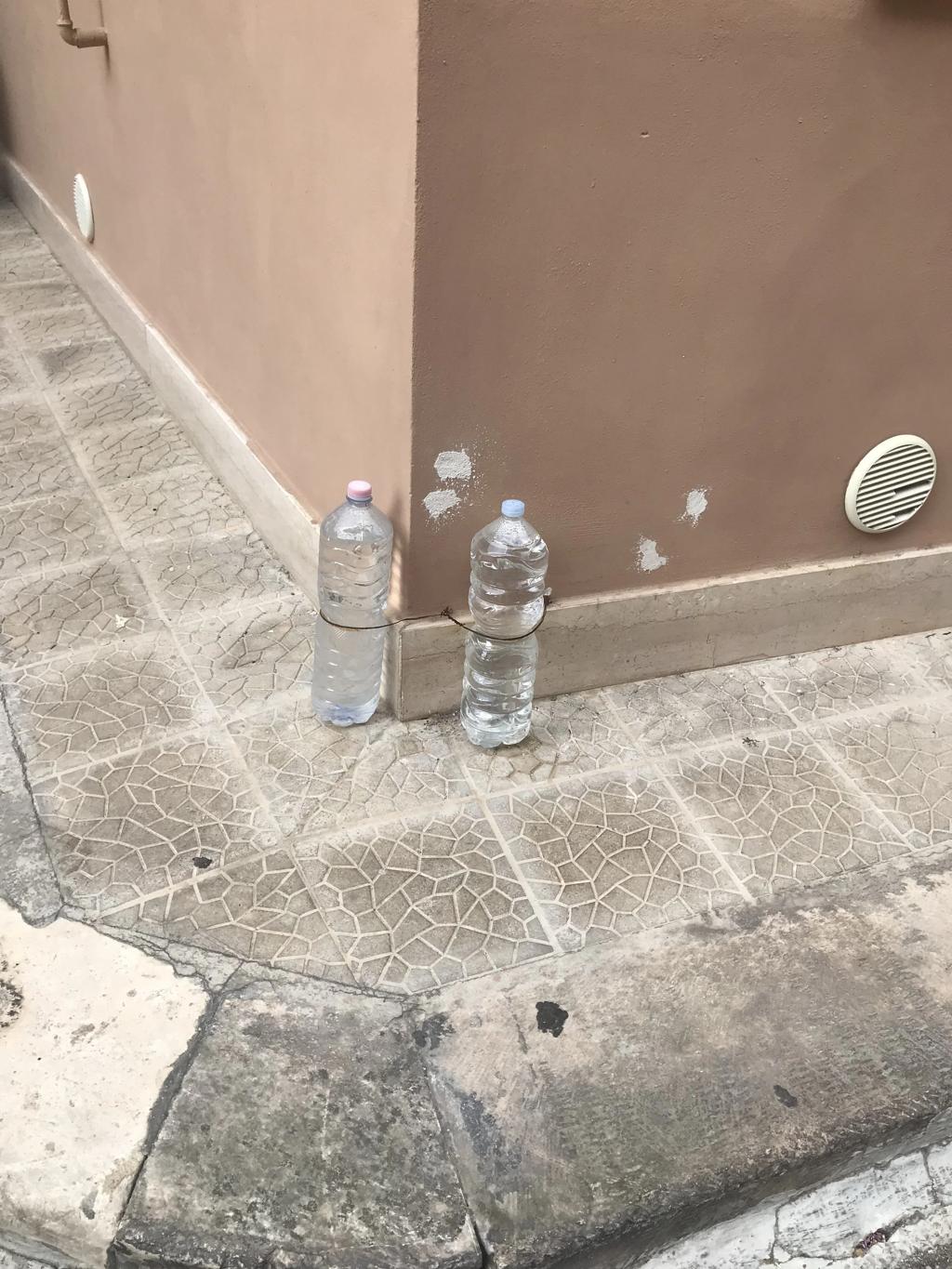 Why Do Maltese People Keep Water-Filled Bottles Outside Their Houses?